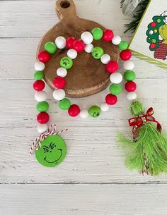 the grinch bracelet is next to a christmas ornament and candy canes