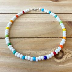 The Confetti beaded anklet is a beautiful white piece with a rainbow of colors sprinkled in. It is the perfect way to add a little something fun to your everyday outfit. All anklets are customizable to the size you need so please be sure to measure your ankle where you want your anklet to sit and order accordingly! This high quality beaded anklet is secured with a sterling silver lobster claw and made with glass beads that can stand the test of time, making it perfect for everyday use. Keep in m White Beaded Anklets For Summer, Adjustable White Anklets With Colorful Beads, White Beaded Anklet For The Beach, White Beaded Anklets For Festival, White Beaded Anklets For Beach, White Beaded Festival Anklets, White Anklets With Colorful Beads For Beach, Colorful Beaded White Anklets As Gift, White Round Bead Anklets For Summer