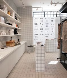 a store with white tiled walls and shelves