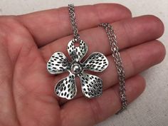 "Big, bold and unique silver flower pendant necklace. simple, refined and eye catching. It has incredible detail and design. The perfect everyday necklace for any nature lover. The pendant measures 1 3/8\" long by 1 3/8\" wide and made from allergy free plated silver. It hangs from a simple shiny 18\" stainless steel necklace chain with a lobster clasp. I have matching earrings in my shop if you would like the whole set. Here is a direct link https://etsy.me/37xz8Ql Thanks for stopping by! Pleas Metal Flower Charm Necklaces, Metal Flower Necklace For Gift, Handmade Silver Flower Necklace, Handmade Silver Flower-shaped Necklace, Silver Flower Shaped Metal Necklace, Silver Flower-shaped Metal Necklace, Silver Metal Flower Pendant Necklace, Silver Metal Pendant Flower Necklace, Silver Flower Pendant Necklace