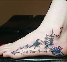 a person with a tattoo on their foot that says adventure awaits and an arrow