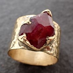 Partially Faceted Ruby Sapphire / Cigar Band / Cocktail / Statement ring I created this setting in wax then cast it in recycled 18k gold at my home studio. This lovely Sapphire ring is a size 7. The stone measures about 10mm X 13mm. The band is around 12mm wide. Throughout all time and history in every tribe and culture all around the world crystals, minerals and gemstones have used for healing, luck, divination, adornment vibrational medicine and so much more. Sapphire is a stone for mental cla Luxury Handmade Antique Ruby Ring, Untreated Recycled Gold Jewelry As A Gift, Untreated Recycled Gold Jewelry Gift, Recycled Gold Untreated Jewelry As A Gift, Unique Untreated 14k Gold Jewelry, Unique Untreated Yellow Gold Jewelry, Artisan 14k Gold Jewelry For Anniversary, Unique 14k Gold Ruby Ring For Anniversary, Hand-forged Wide Band Jewelry For Anniversary