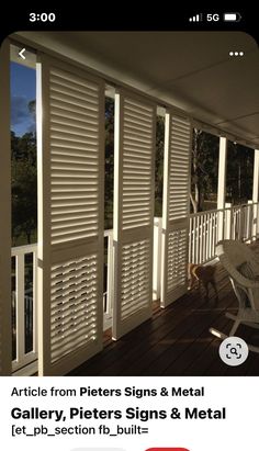 a dog is standing on the porch next to shutters