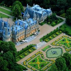 an aerial view of a large building surrounded by trees