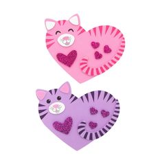 two pink and purple heart shaped magnets with cats on them