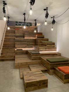 a room filled with lots of wooden steps next to a set of stools and lights