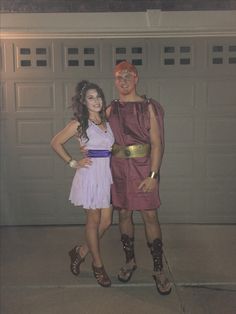 a man and woman dressed up in costume standing next to each other near a garage door