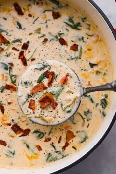 a ladle full of soup with bacon and spinach