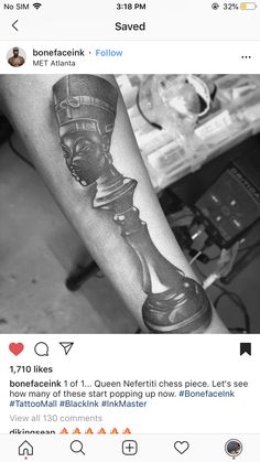 a black and white photo of a man's arm with a chess piece on it