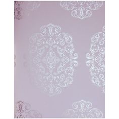 an ornate wallpaper with white designs on the walls in a room that has been painted pink