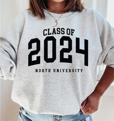 Personalized Graduation Year Hooded Sweatshirt - Personalized Sweatshirt - Custom college sweater - College sweatshirt - University of How to Order 1* View all color and size charts before you place your order. 2* Select your shirt "SIZE" and "COLOR". 3* Click add to cart.  If you are ordering more than 1 item, you need to repeat this process for each item you wish to order. Product Information Gildan Hoodie- Sweatshirt 8 oz.(US) 13.3 oz.(CA), 50/50 preshrunk cotton/polyester Heather Sport color Gray Collegiate Long Sleeve Sweatshirt, Varsity Long Sleeve School Hoodie, Varsity Long Sleeve Hoodie For School, Fall Varsity Hoodie For School, Sporty Crew Neck School Hoodie, College Sweater With Letter Print And Long Sleeves, School Hoodie Sweatshirt With Letter Print, Letter Print Hoodie Sweatshirt For School, Collegiate Letter Print Sweater For Campus