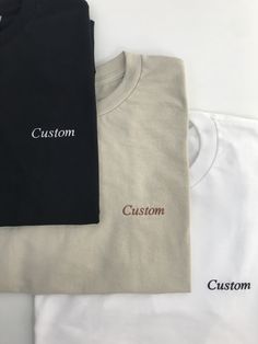 This listing is for a custom embroidered UNISEX short sleeve t-shirt. The more text you add the smaller the text will be. Interested in a different shirt color, thread color, font, etc? Message us on Etsy to make a request. Please see the size chart in the product listing photos to determine the best size for you. Custom embroidered shirts make a gift for any occasion - anniversary, bachelor party, bachelorette party, back to school, birthday, engagement, graduation, sweet 16's and quinceañera's, retirement, and weddings. They're also perfect for any holiday because this tee is customizable - Valentine's Day, St. Patrick's Day, Easter, Mother's Day, Father's Day, Halloween, Thanksgiving, Hanukkah, Christmas, and more. Care instructions: Please wash on cold and dry on low. Currently product Roman Numerals Dates, Lyric Shirts, Simple Graphic, Embroidered Shorts, Font Names, Embroidered Clothes, Make A Gift, Custom Fonts, Unisex Shorts