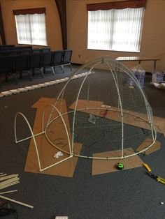 the inside of a building that is being constructed with cardboard and construction tools on the floor