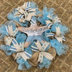 a blue and white wreath with the word welcome on it