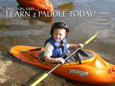 a young boy in an orange kayak with the words learn 2 paddle today on it