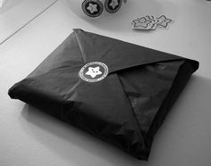 a black envelope sitting on top of a table