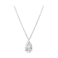 This exquisite pendant necklace features a stunning 4.22 carat pear cut diamond, gracefully suspended from a delicate 18K white gold chain. The diamond exhibits an E color grade, offering a near colorless brilliance that exudes sophistication. It's VS1 clarity ensures minimal inclusions, resulting in exceptional transparency and beauty. The excellent polish creates a flawlessly smooth surface that enhances the diamond’s radiant sparkle. With very good symmetry, the facets are precisely aligned, Luxury White Gold Teardrop Pendant Necklace, Luxury Oval Platinum Diamond Necklace, Pear Diamond Pendant, White Gold Chain, Expensive Jewelry Luxury, White Gold Set, White Gold Chains, Pear Cut Diamond, Expensive Jewelry