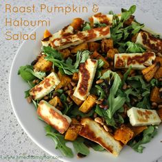 a white plate topped with tofu and greens