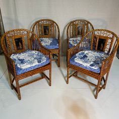 three bamboo chairs with blue and white designs on them, sitting side by side in front of a wall