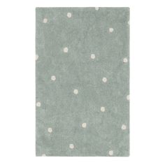 a green rug with white polka dots on it