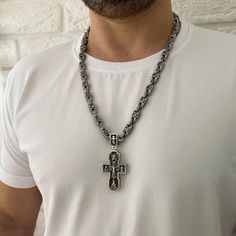 "Material: 925 Sterling Silver Weight: 150 gr. Width: 8/9mm Silver Orthodox cross. Silver 925 with blackening. Weight 57 grams (+ -) The size: 7 / 3.2 cm (with eyelet) 5 / 3.2 cm (excluding the lug) The cross depicts: Savior Not Made by Hands Crucifixion of jesus christ Kazan Icon of the Mother of God Nicholas the Wonderworker Sergius of Radonezh archangel Michael Prince Vladimir Archangel Gabriel George the Victorious At the end of the cross there is a prayer: \"Lord Jesus Christ, Son of God, H Silver Symbolic Cross Necklace, White Cross Chain Jewelry, White Cross-shaped Chain Jewelry, Silver Hallmarked Cross Necklace, Hallmarked Silver Cross Necklace, Silver Cross Pendant Necklace, Symbolic Silver Cross Jewelry, Symbolic Silver Cross Necklace, Silver Hallmarked Cross Pendant Jewelry