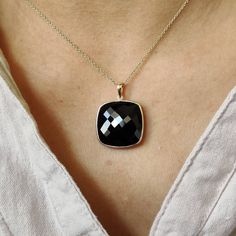 ITEM DESCRIPTION: >>The pendant is made from Solid 14K Yellow Gold. Gemstone used is absolutely natural and ethically sourced. >>Natural Black Onyx of cushion shape in bezel setting is studded on it with utmost precision. >>This is a minimalist design and is absolutely hassle-free and everyday jewelry. Gem: Black Onyx Gem size: 20x20 mm Gem weight: 19.71 carats Gold purity: 14K (58.33% approx.) Gold weight: 0.74 grams Gross weight: 4.68 grams The Gold purity is guaranteed and it comes with authe Black 14k Gold Pendant Jewelry, Yellow Gold Necklace With Black Diamonds As Gift, Black Faceted Jewelry As A Gift, Black Pendant Jewelry For Anniversary, Black Faceted Jewelry For Gift, Elegant 14k Gold Jewelry With Black Diamonds, Black 14k Gold Jewelry With Bezel Setting, Fine Jewelry Onyx With Black Diamonds, Fine Jewelry With Black Diamonds And Onyx