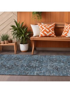 a wooden bench sitting on top of a hard wood floor next to two planters