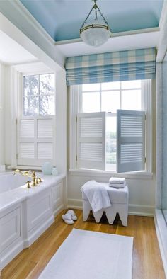 a bath room with a tub a sink and a window