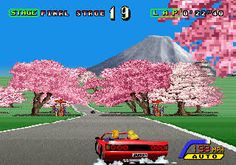 an old - school video game with cars driving down the road in front of cherry blossom trees