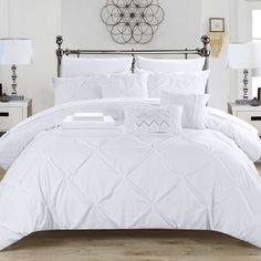 a white comforter set on a bed in a room