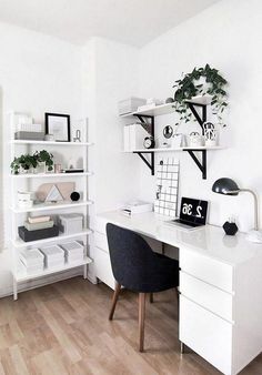 a white desk with black chair and shelves on the wall in a home office area