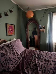 a bedroom with green walls and purple bedding