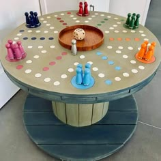 a game table with colorful pegs on it and a wooden board in the middle