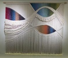 a wall hanging made out of yarn and string