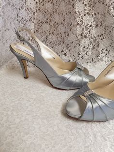 "Beautiful silver heels, sample sale, they been worn for a short time to take pictures, the outer sole has walk on marks but, other than that shoes are in perfect condition! Price reflects comment above. Thank you! Only one pairs Size: 10 Heel: 3 1/4\" Inside length: 10 5/8\" PLEASE MEASURE YOUR FEET LENGTH TO ENSURE FIT. FINAL SALE, NO RETURNS, NO EXCHANGES, NO EXCEPTIONS. PLEASE CONTACT FOR ANY ADDITIONAL QUESTIONS OR, CONCERNS. THANK YOU!" Metallic Silver Heels With Round Toe For Formal Occasions, Silver High Heels For Anniversary, Silver Heels With Heel Strap And Round Toe, Elegant Round Toe Heels With Silver Accents, Metallic Silver High Heels For Wedding, Silver Open Heel Wedding Shoes For Formal Occasion, Silver Heels With Padded Heel And Round Toe, Formal Open Toe Heels With Silver Accents, Elegant Open Toe Heels With Silver Accents