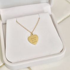 The engravable Medium Size Heart Necklace is composed of 14K solid gold and beautifully complemented by a durable matching 14K solid gold faceted cable chain. This piece is adjustable in length or available to be purchased as a charm alone without the chain. Heart Dimensions: approximately 12mm (w) x 14mm (h) Metal Finish: High Shine Polish This design is available in Rose, White and Yellow 14K Gold This item is proudly made in USA and also available in 18K solid gold options upon request. Kindl Customizable Gold Heart Pendant Jewelry, Personalized Heart-shaped Yellow Gold Charm Necklace, Personalized Yellow Gold Heart Pendant Charm Necklace, Personalized Yellow Gold Heart Charm Necklace, Gold Heart Necklace Stamped 14k For Wedding, Personalized Round Pendant Heart Necklace In Yellow Gold, Personalized Yellow Gold Round Pendant Heart Necklace, Rose Gold Heart Cut Charm Necklace For Anniversary, Engraved Yellow Gold Heart Necklace For Wedding