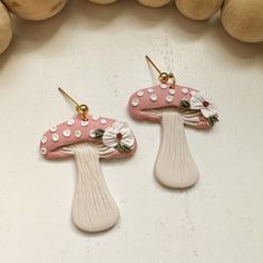 Handmade polymer clay earrings Clay pink mushroom dangle earrings with flowers.  Clay mushroom floral earrings Handmade floral pink mushroom clay earrings. These clay mushroom earrings are created from high quality clay and are nickel free. These earrings are super lightweight! They also make the perfect cottagecore statement earrings! * Nickel Free * Super Lightweight  * Each pair of earrings is handmade and uniquely designed! No two are alike! ** FIND SIMILAR EARRING STYLES HERE: https://www.e Trendy Clay Earrings, Mushroom Clay Earrings, Mushroom Clay Earrings Flat, Clay Mushroom Earrings, Cottage Core Polymer Clay Earrings, Clay Mushrooms Jewelry, Polymer Clay Mushroom Design Jewelry Gift, Mushroom Clay, Earrings Mushroom