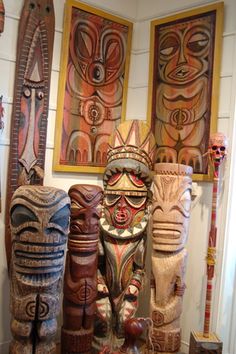 several wooden carvings are on display in a room