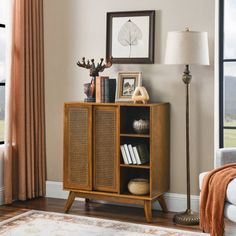 a living room scene with focus on the sideboard and bookshelf in the foreground