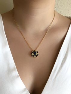 "Round Evil Eye Charm This is an 18K gold plating 2mm box chain necklace with a black and blue colored round cubic zirconia \"0.75 / 1.90 cm evil eye pendant. This is a simple but eye-catching necklace. It's a great look for daytime, clean line, fashion, and urban look, and could be a perfect birthday, mother's day or Christmas gift. Details: 18K Gold Plated 2mm box chain. 0.75\" / 1.90 cm Evil Eye 18K gold plated pendant. Approximate length: 17.2\" or 45 cm. Each item is carefully shipped in an Gold Plated Jewelry With Round Pendant And Box Chain, Gold Plated Black Jewelry For Gift, Gold-plated Jewelry With Round Pendant Box Chain, Black Gold Plated Jewelry As Gift, Black Gold Plated Jewelry For Gift, Black Gold Plated Jewelry Gift, Black Gold-plated Jewelry For Gifts, Black Gold Plated Charm Necklace With Adjustable Chain, Black Round Pendant Necklace, Gold Plated