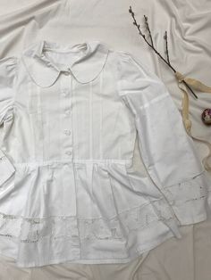 Amazingly detailed vintage 40's/50's blaser or blouse with extreme puff sleeves, peplum and cotton buttons, petern pan collar and cut out lace richelieau with roses. Goes well with an understated crop top and high waisted jeans. Very Rouje-esque, but Eastern European + original. Sits a size small to large. Measurements soon. Excellent condition, rare piece. Vintage Lace Blouse For Fall, Fitted Doll Collar Top For Fall, Vintage Fitted Tops With Broderie Anglaise, Vintage Lace Collar Button-up Top, Cotton Cottagecore Top With Doll Collar, Spring Vintage White Blouse With Ruffles, Fitted Button-up Blouse With Lace Collar, Classic Puff Sleeve Top With Lace Trim, Feminine Cotton Blouse With Lace Cuffs