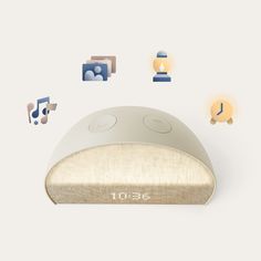 an alarm clock sitting on top of a white surface next to various icons and symbols