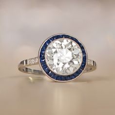 a diamond and blue sapphire ring on a table