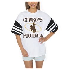 Showcase your Wyoming Cowboys pride in style with the Gameday Couture Starting Lineup Contrast Sporty Heritage Oversized T-Shirt. The oversized fit provides a trendy and relaxed look, making it perfect for game day or any casual occasion. Made from 100% cotton, this tee offers exceptional comfort and breathability, ensuring you stay cool and confident while cheering on the Wyoming Cowboys. Oversized School Spirit T-shirt With Letter Print, Retro Tops For Football Season Streetwear, Retro Tops For Streetwear During Football Season, Collegiate Relaxed Fit Tops For Football Season, White Oversized Tops For School Spirit, Football Season Streetwear Tops With Text Print, Retro Tops For College Football Season, Oversized Collegiate Short Sleeve T-shirt, Streetwear Tops With Text Print For Football Season