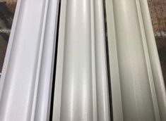 three different types of white plastic sheeting on the floor in a room with wood floors