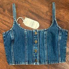 Brand New W/ Tags!! This Is The Cutest Lil Denim Crop! It Has Adjustable Straps And The Quality Is Amazing!! Size Small! I Wear A 34b And This Small Fits Perfect For Reference;)) I Should Be Getting More Sizes In Soon! *Feel Free To Ask Any Questions!! *Made By The Australian Company Ghanda But I’m Listing Under Free People Because Such A Similar Style/Vibe! Dark Wash Cropped Top With Button Closure, High Waist Denim Tops For Spring, High Waist Denim Blue Cotton Crop Top, Summer Dark Wash Cotton Crop Top, Summer Cropped Denim Top With Button Closure, Dark Wash Cotton Crop Top For Summer, Fitted Denim Crop Top, Casual Style, Trendy Medium Wash Cotton Denim Top, Dark Wash Cropped Denim Tops