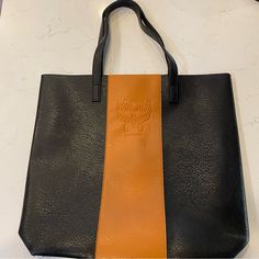 Mcm Parfums Black And Tan Faux Leather Tote Bag. Never Used And In Perfect Condition. Black Shoulder Bag For Business In Fall, Black Leather Shoulder Bag With Removable Pouch, Black Leather Shoulder Bag With Leather Trim, Black Leather Shoulder Bag With Leather Handles, Fall Black Bags With Leather Lining, Black Leather Lined Bags For Fall, Black Leather-lined Bags For Fall, Fall Soft Leather Black Bag, Black Soft Leather Bags For Fall