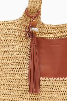 Our Kamari Tote is a refined, everyday bag made all the more elegant thanks to subtle detailing. Hand-woven from natural raffia, it has a roomy interior that’s unlined to maintain its drapey silhouette and has two top handles you can easily slip over your shoulder. A whipstitched-trimmed leather pocket on the outside secures smaller items, while the leather tassel with antique brass ring adds an elevated touch. Composition: 100% Polypropene Pair with the Menorca Maillot to complete the look. Nyc Boutiques, Everyday Handbag, Leather Pocket, Menorca, Brass Ring, Tote Handbag, Signature Print, Handbag Shoes, Leather Tassel