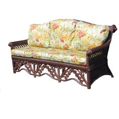 a wicker couch with flowers on the back and seat cushion is shown in front of a white background