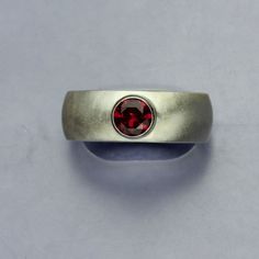 "Ruby Silver Ring, Lab Faceted Red Ruby Sterling Silver, Wide Band, Unisex Ring Beautiful ring that started out as a hand carved wax. I then cast the wax sculpture of the ring with the finest sterling silver using the lost wax casting method. The result was this stunning ring, featuring a lab created Ruby that l set in the center. I gave this ring a matte finish to the .925 Sterling Silver. Ring is Size 10 This Ruby gemstone has the same optical and physical properties as a natural Ruby. The onl Ruby Silver Ring, Wax Sculpture, Physical Properties, Wax Casting, Lost Wax Casting, Unisex Ring, Ruby Gemstone, Lost Wax, Red Ruby